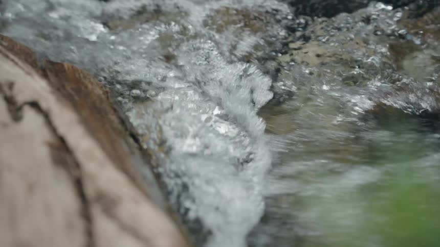 The stream is running fast over the rocks