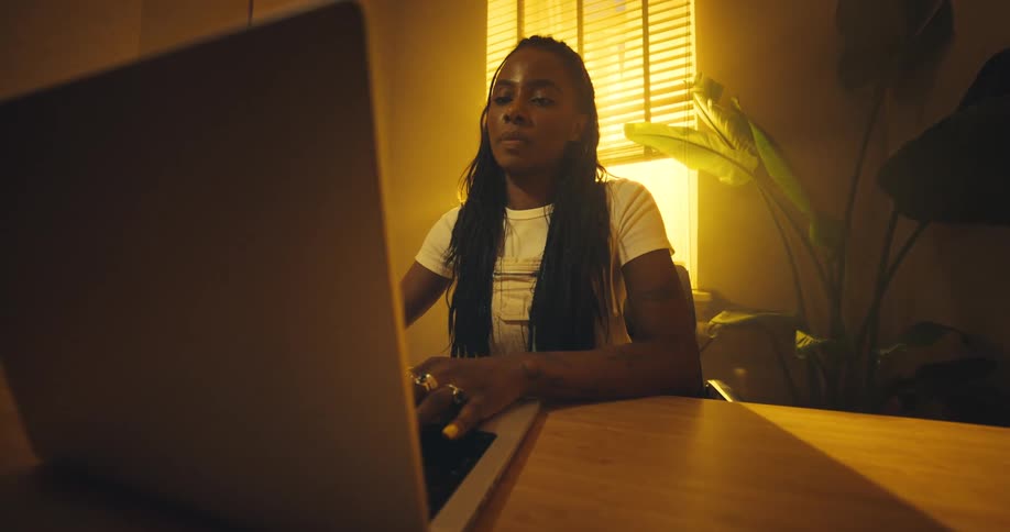 A woman opening up a laptop computer