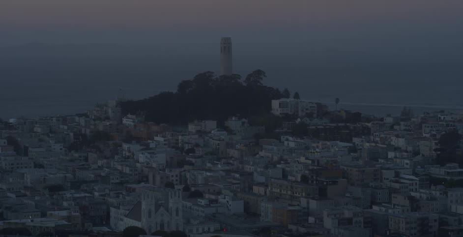 A lighthouse sits on a hill by this coastal town