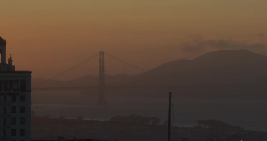 The bridge is covered with fog at dawn