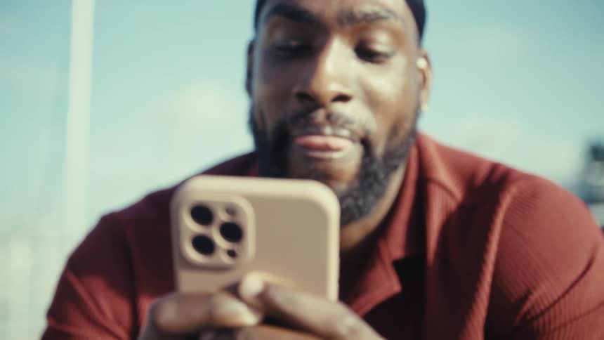 A man using a smartphone outdoors