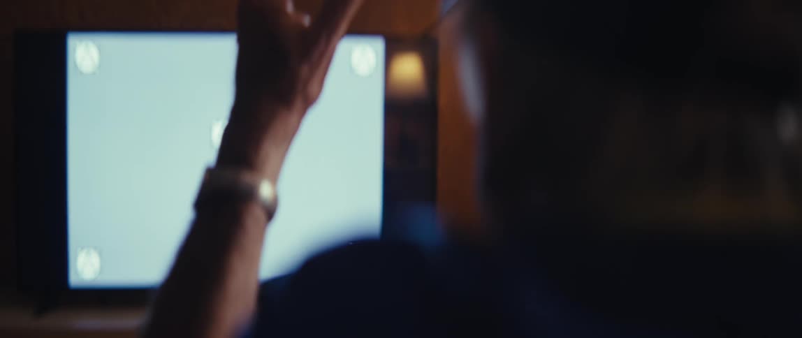 The man cheers and claps at the television