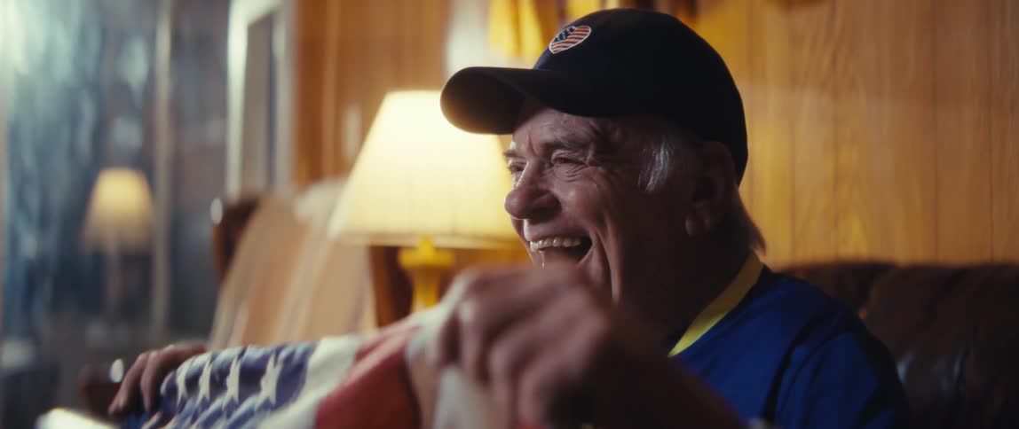 A man cheering while holding a flag