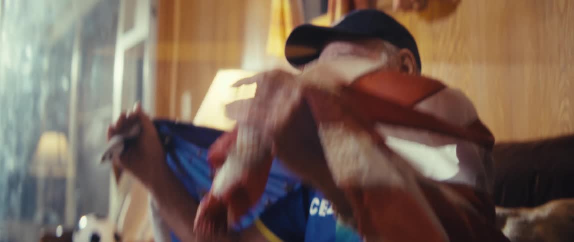 A man yelling while watching sports on tv