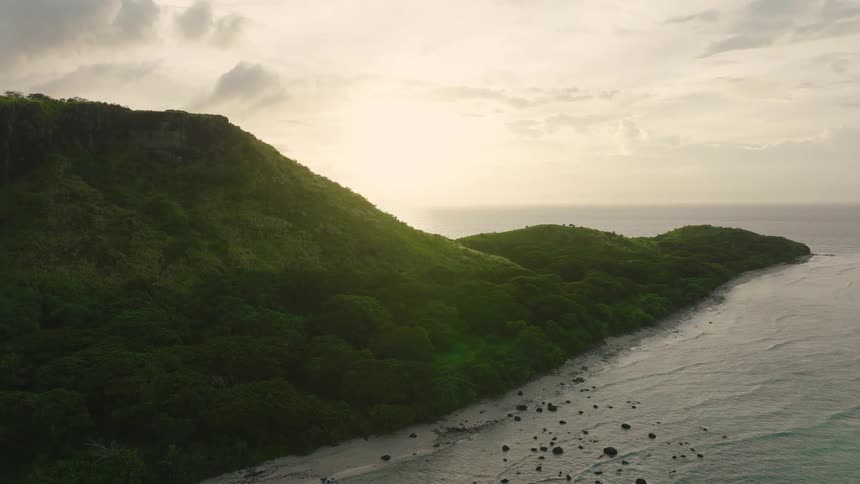The sun is rising on the tropical island