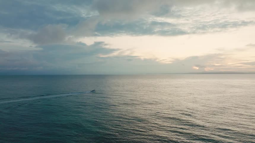 The boat is traveling past the small island