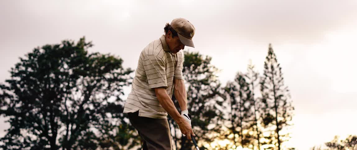 A man golfing outdoors