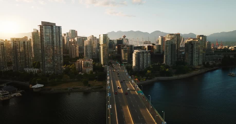 Traffic moves over the large bridge going through the city