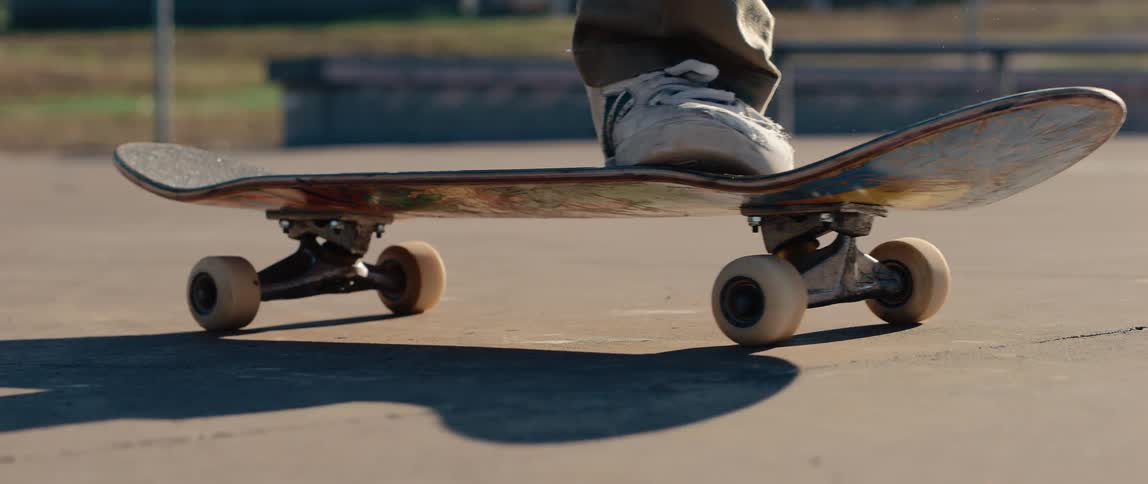 A person on a skateboard lands as they do a trick
