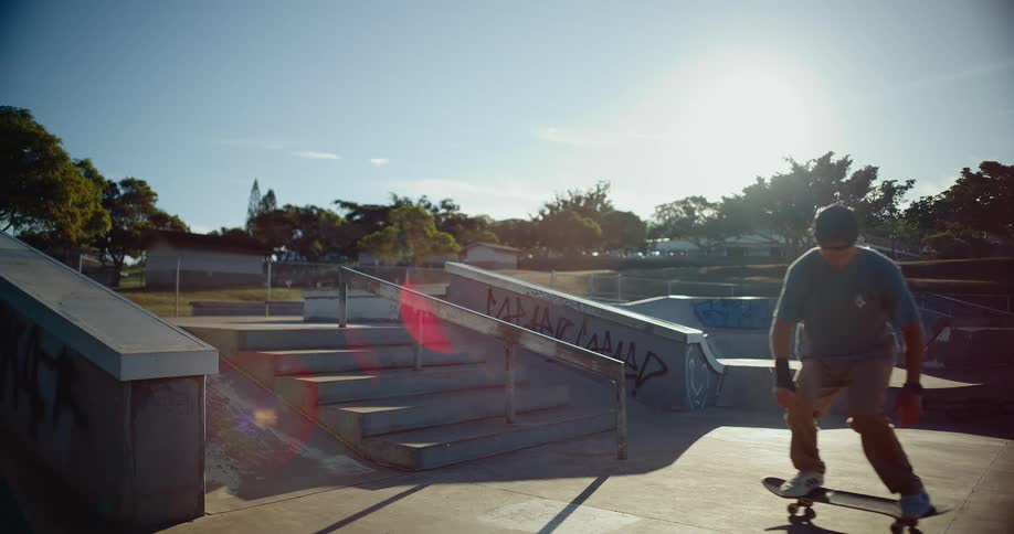 Teenage boy on a skateboard leaps over stairs and maintains balance on his skateboard