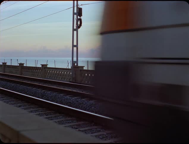 Highspeed train blurs past platform with metallic reflections and motion lines