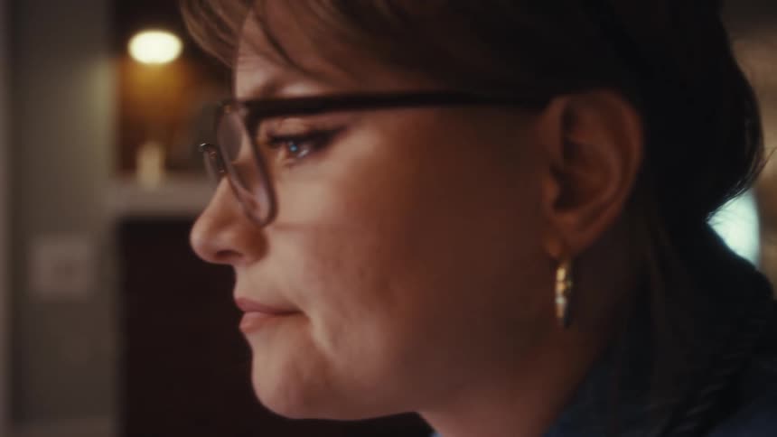 The woman thinks while typing on her computer