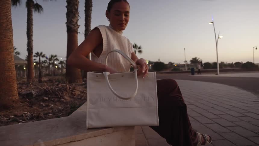 A woman getting a phone out of a bag