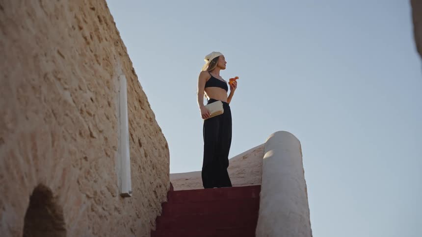 A woman standing outdoors modeling clothes