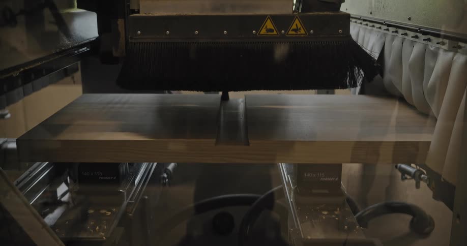 Industrial machine performs automated cutting on a wooden panel