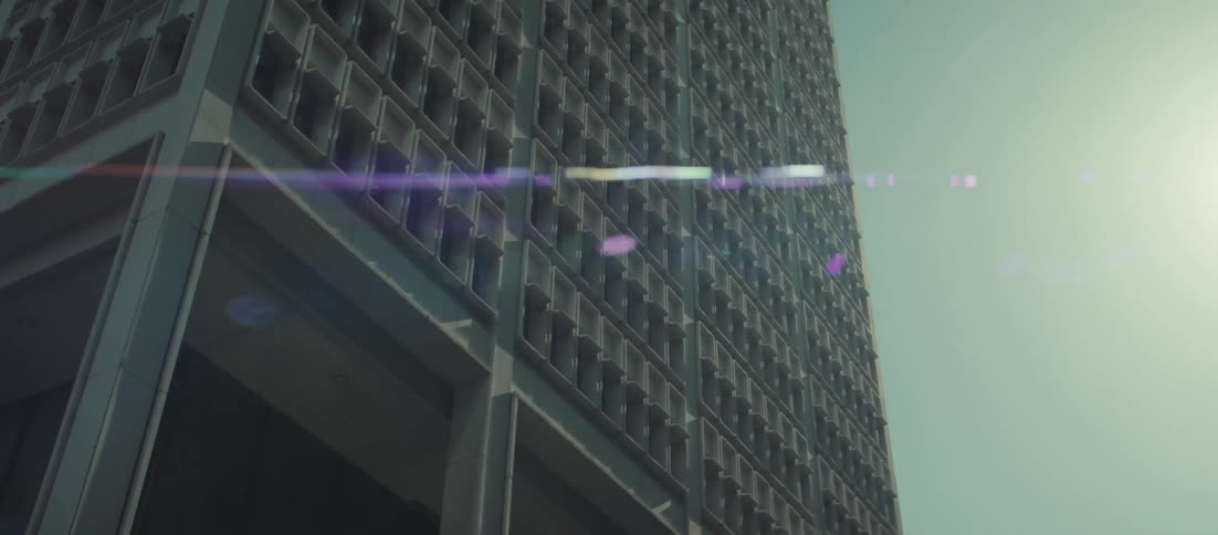 The sun shines on the tall building