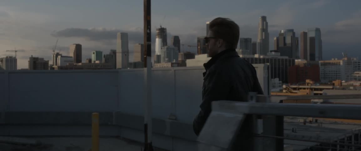 A man climbs up the steps before a city