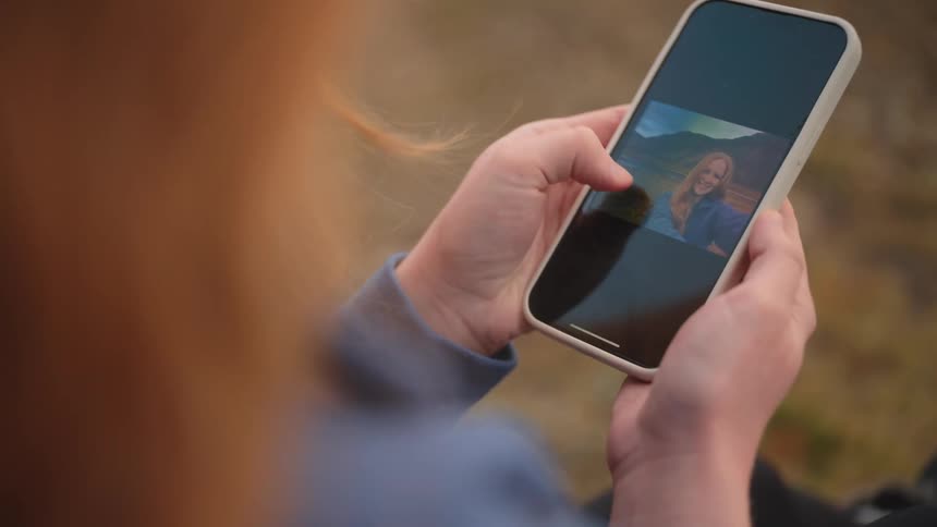 A woman is scrolling on her cellphone