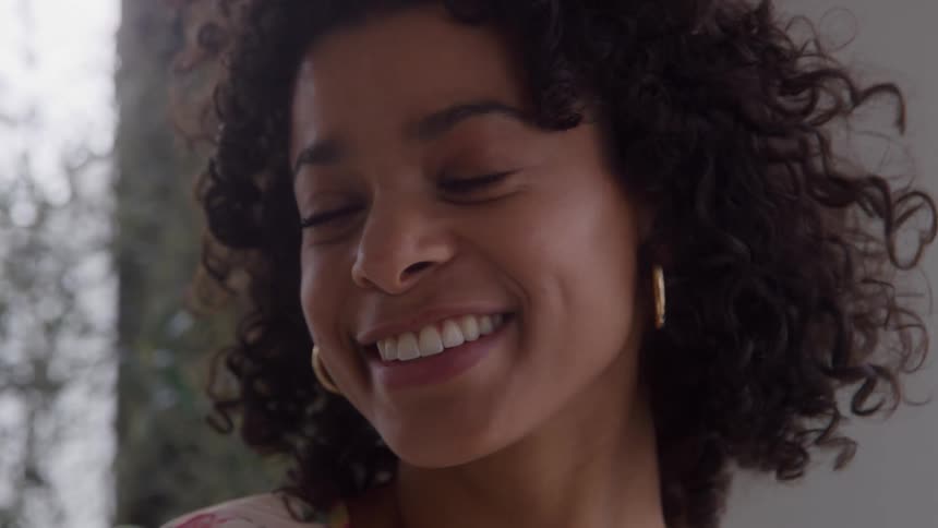 Young biracial woman smiling outdoors during day time