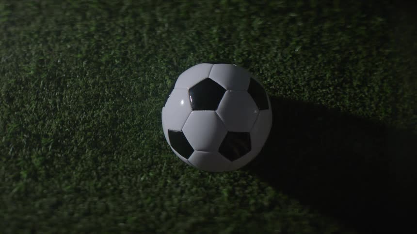 Soccer ball bounces on the grass