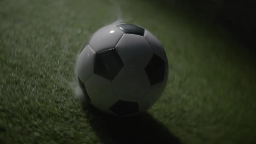 Soccer ball on a field with smoke coming out of it