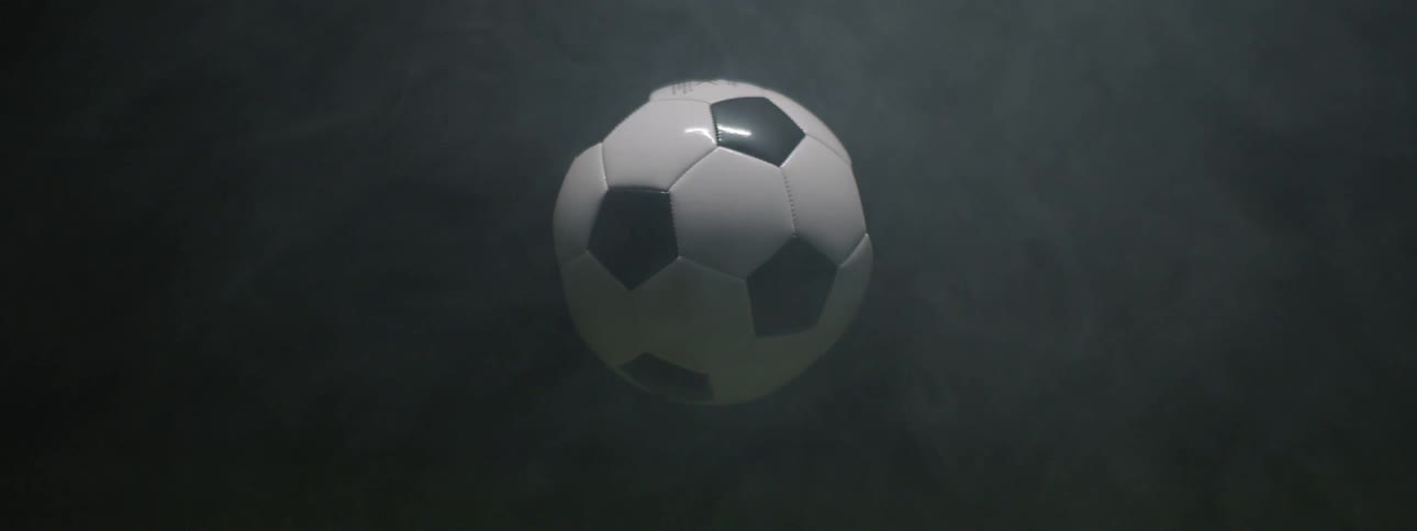 Soccer ball highlighted against smoky dark background
