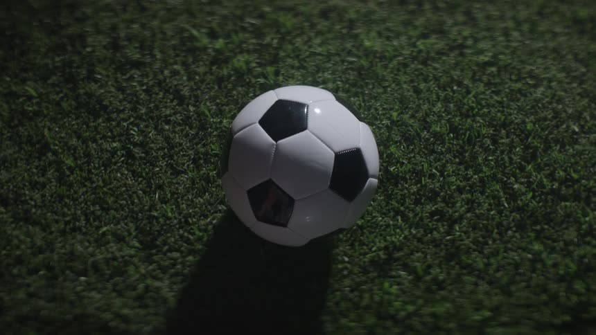 Soccer ball centered on grass