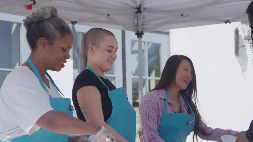 Volunteers serve food at a community event