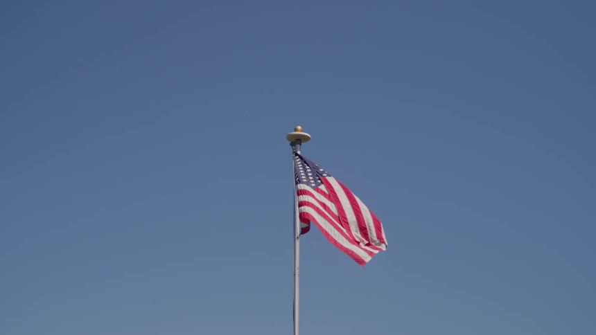 American flag flaps in the wind during the daytime