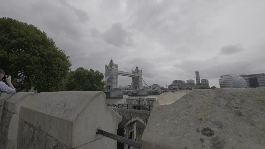 A man is taking photographs of a city below