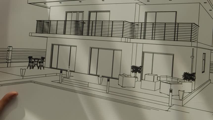 A person looking at blueprints