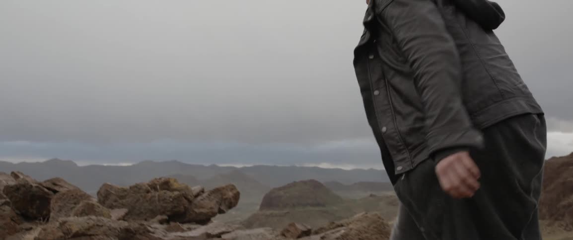 A man is climbing over rocks on a range