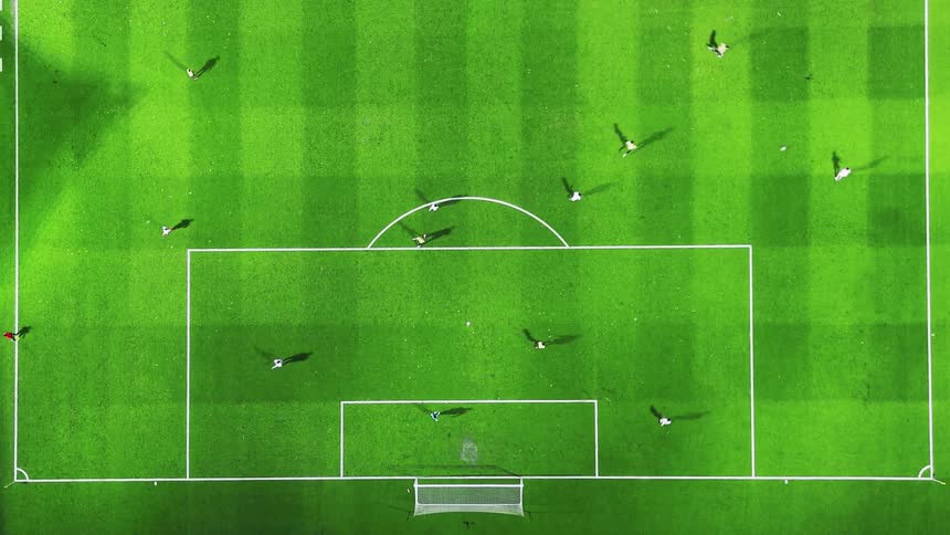 Teams are playing soccer on a grass field