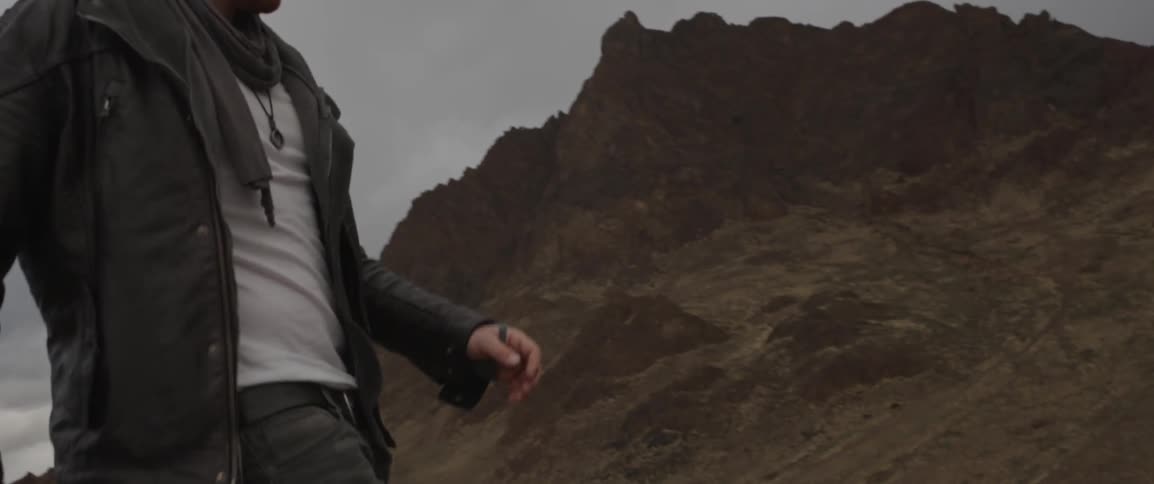 A man walking in the mountains on a cloudy day