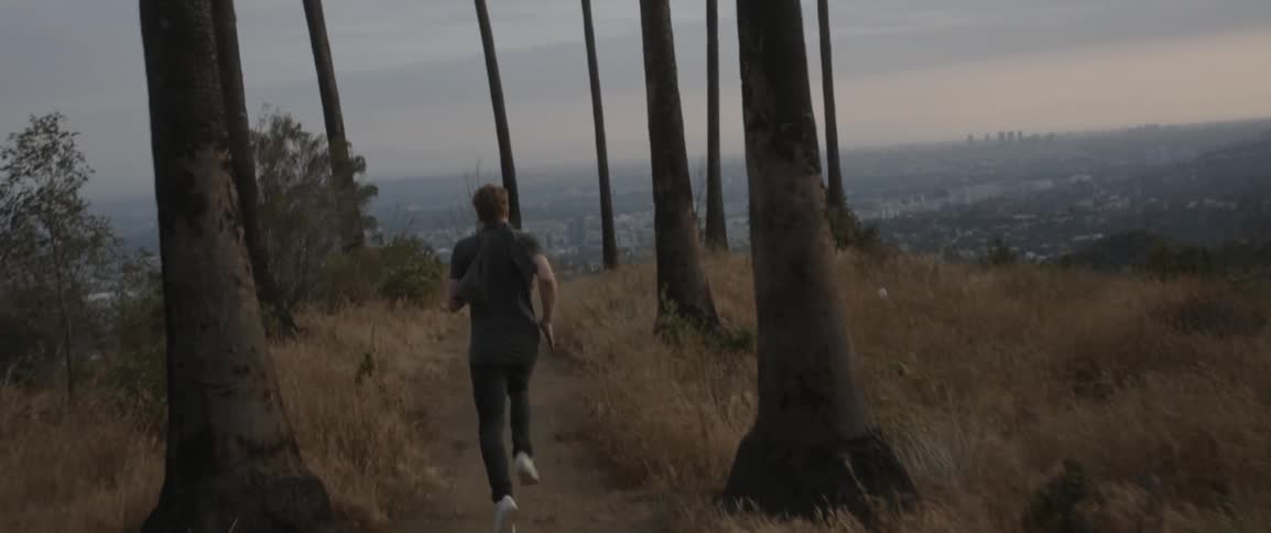 A man is running on a hillside