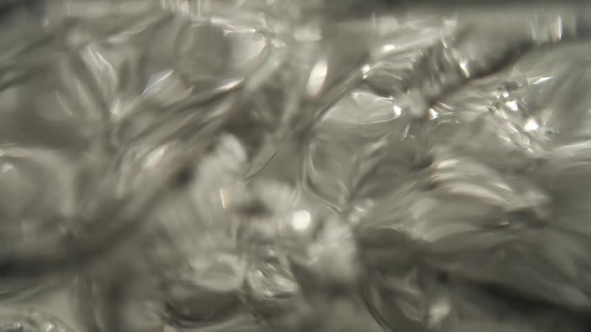 Large bubbles form as the water is boiling