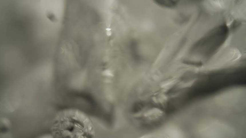 The water is boiling with bubbles rising together