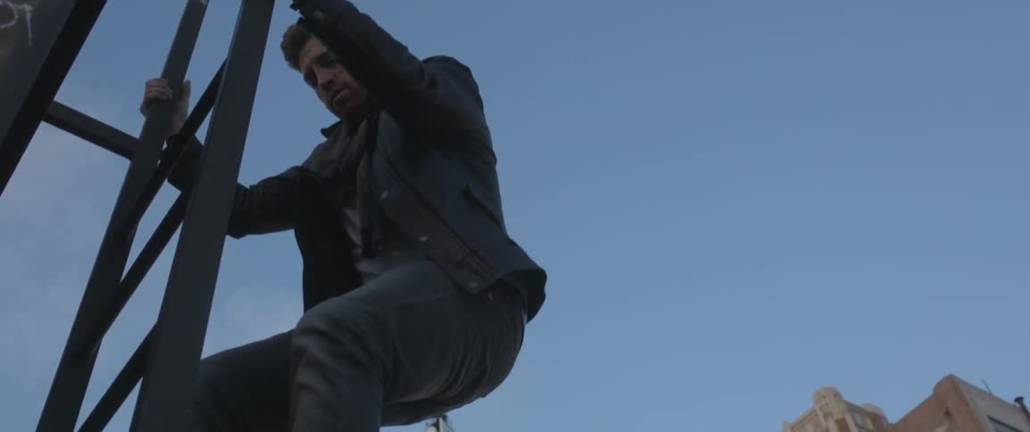 A man is climbing down a ladder