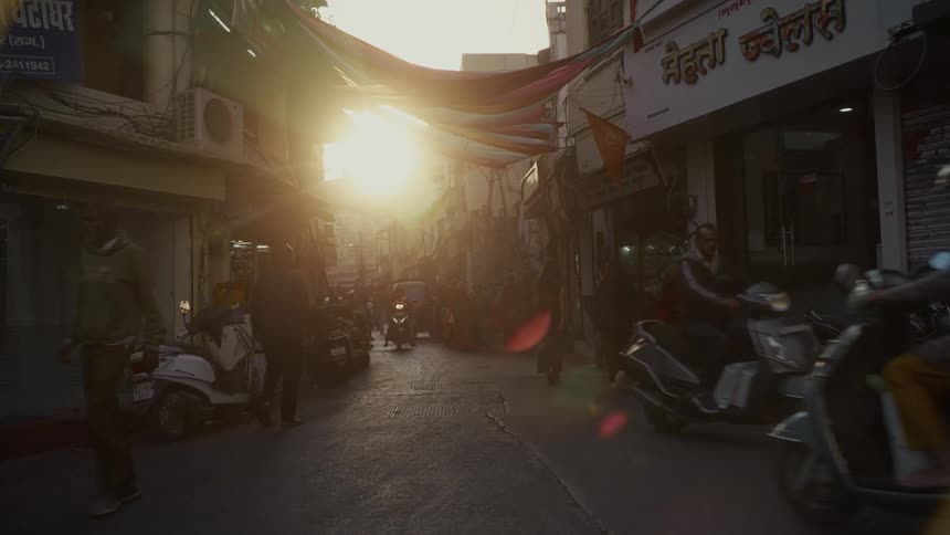 People riding scooters in an alley