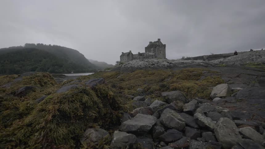 An old building sits on a rocky hill