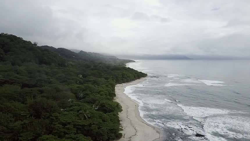 Ocean waves flow towards a sandy beach