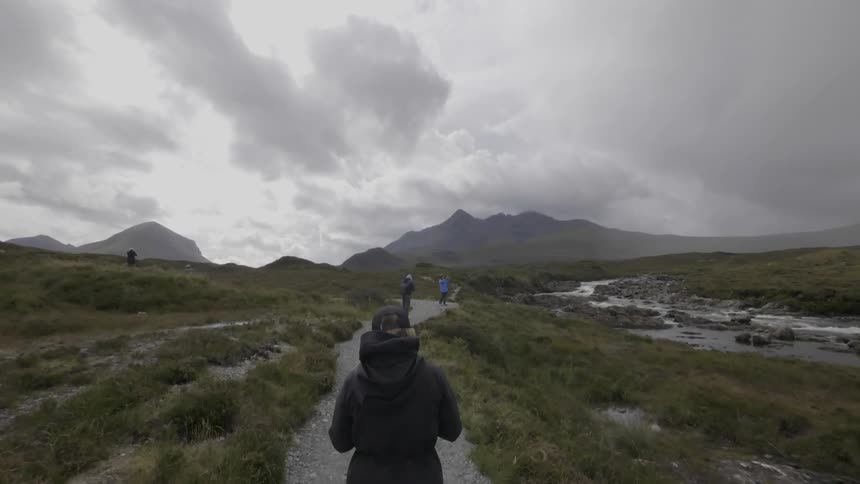 People walking on a gravelly path