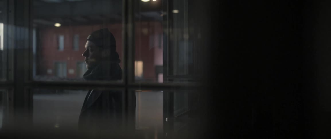 A man walks past a window