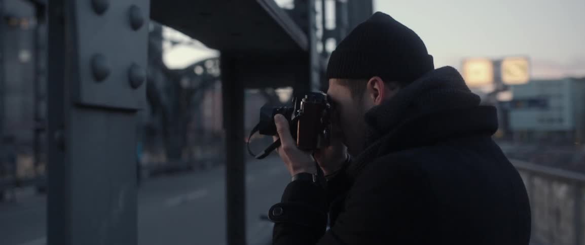 A man is taking photographs at sunset