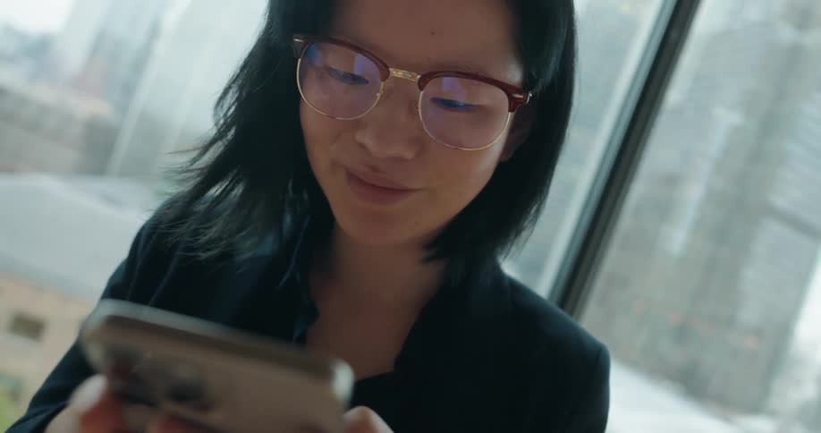 A woman texting on a smartphone