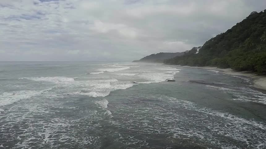 The waves crash against the shore below