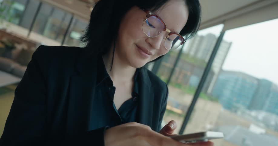 A woman using a smartphone in a room