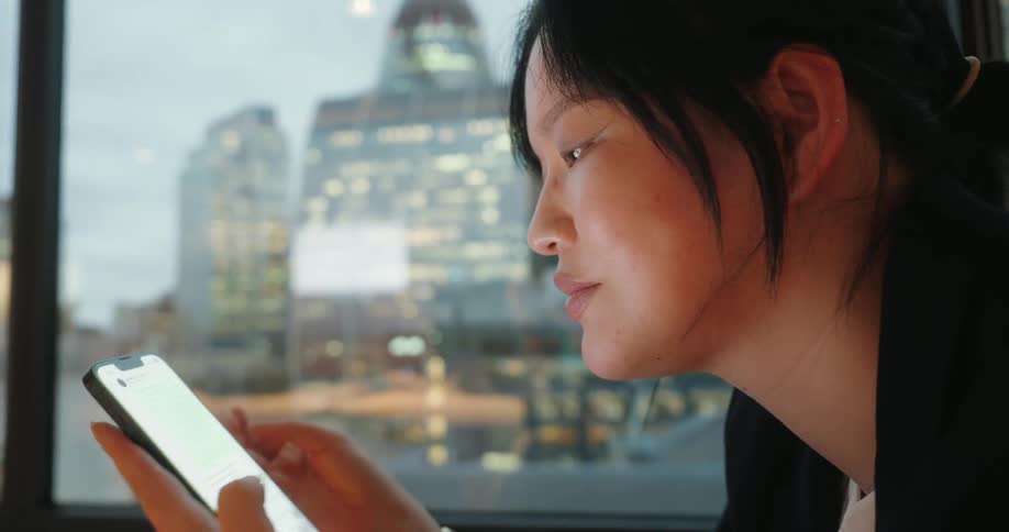 A woman sitting around using a smartphone