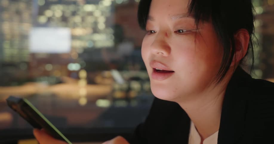 Woman takes off glasses and interacts with her cell phone