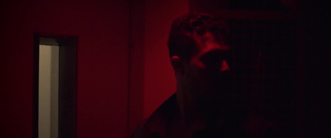 Man standing and looking around in dark room